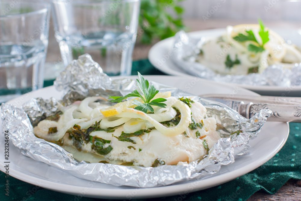 Cod baked in foil with parsley and onion, horizontal Cod baked in foil with parsley and onion, horizontal