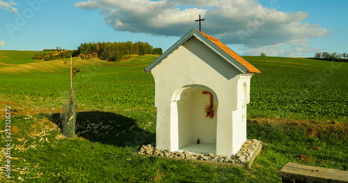 A field with a small church that invites to relax during a sunny day in Moravian Tuscany during the autumn. Beautifully captured two field colors and a blue sky filled with marbles.
