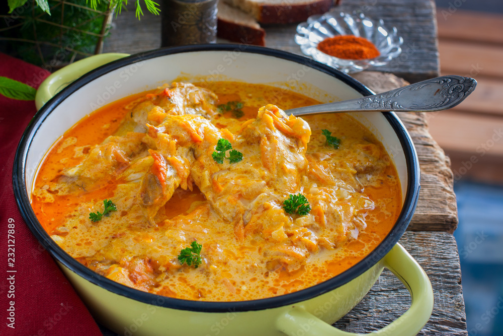 Pumpkin paprikash with chicken in a rustic style, horizontal