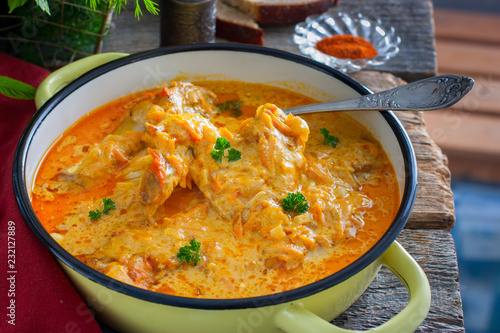 Pumpkin paprikash with chicken in a rustic style, horizontal