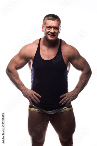 large powerful man showing his muscles in the Studio on white background