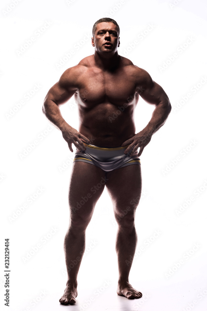 large powerful man showing his muscles in the Studio without a shirt on white background