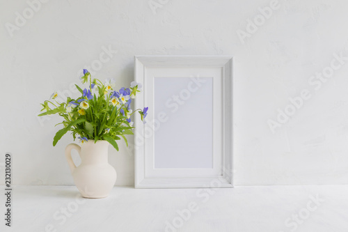 Mockup with a white frame and summer flowers in a vase