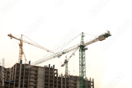 Construction site background. Hoisting cranes and new multi-storey buildings. Copy space for text. ndustrial background.