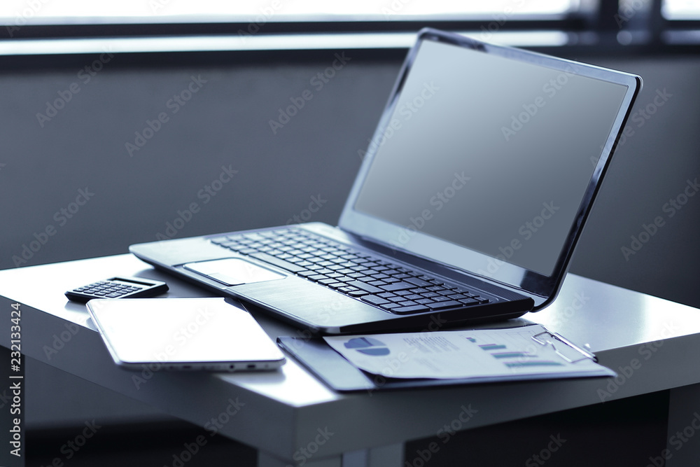 close up. laptop and financial documents on the table close up. laptop and financial documents on the table
