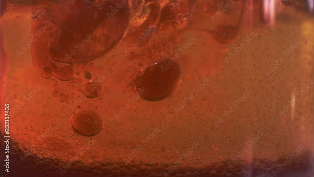 Red liquid with air bubbles Red liquid with air bubbles