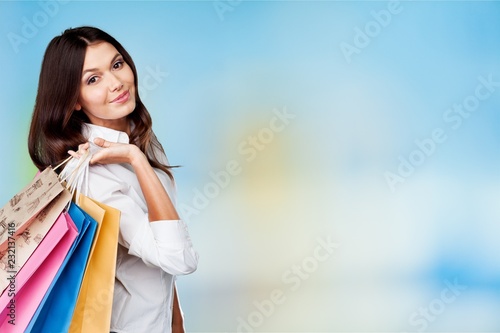 Young woman with shopping bags on blurred shopping mall