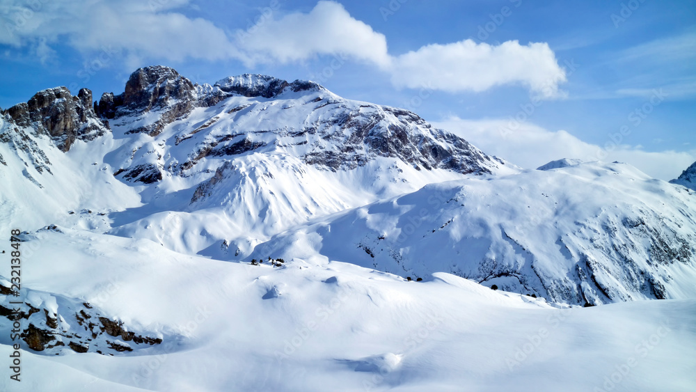 Alpine snowy peaks panorama with slopes, off piste on fresh powder in 3 Valleys winter sport resort, Alps, France, on a sunny cold day .