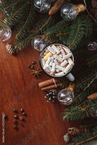 Chocolate or cocoa with marshmallow and garland on a wooden background.