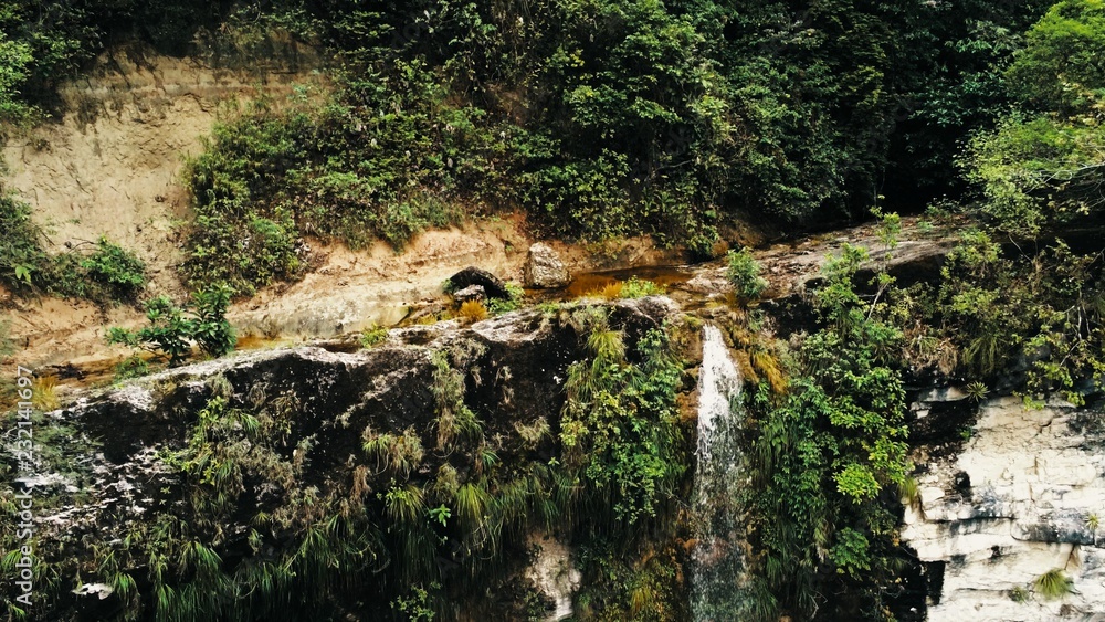 Cinematic aerial drone photo of waterfall and a small pool deep in the rainforest jungle at Amboro National Park, Bolivia Cinematic aerial drone photo of waterfall and a small pool deep in the rainforest jungle at Amboro National Park, Bolivia