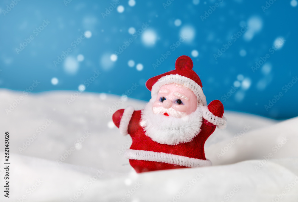 santa claus  figurine standing on the snow. christmas and new year season concept