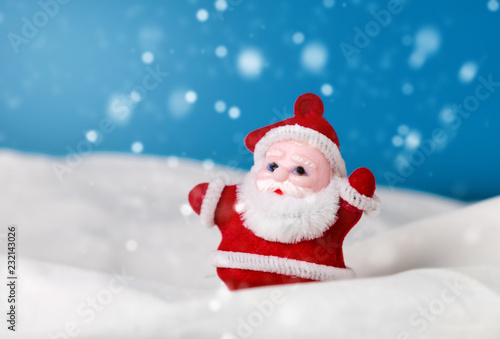 santa claus  figurine standing on the snow. christmas and new year season concept © boydz1980