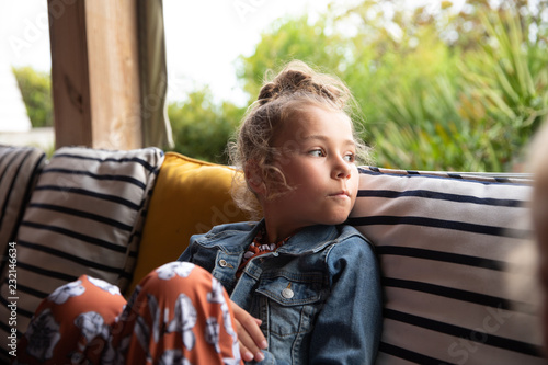 Portrait of a Young Girl Sitting Outdoors