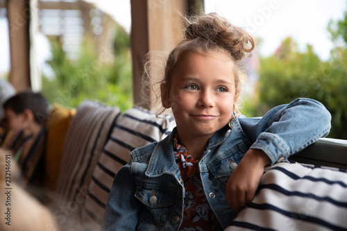 Portrait of a Young Girl Sitting Outdoors