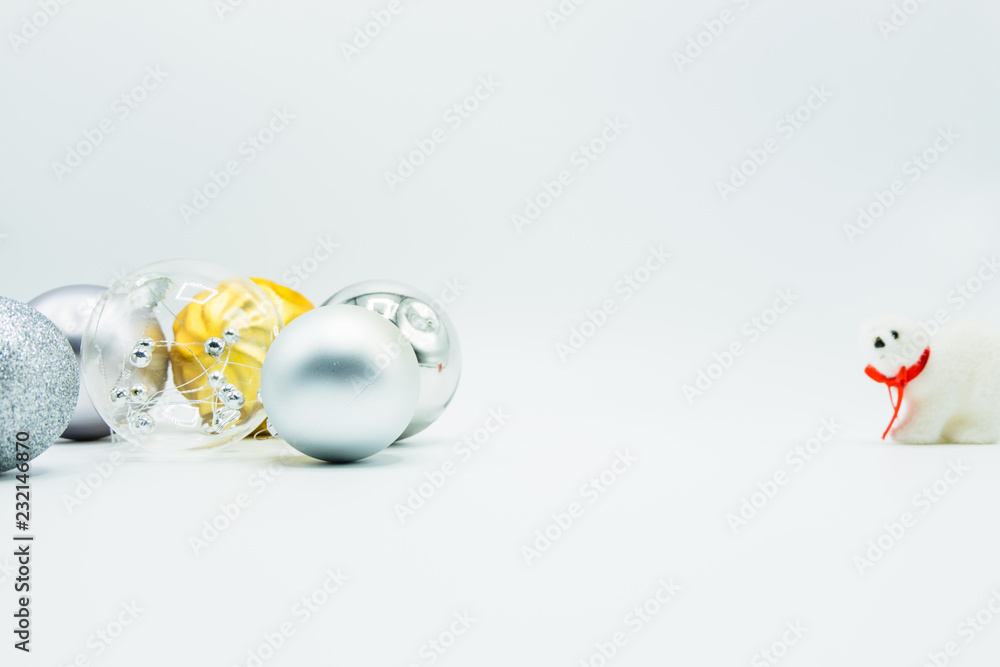 Silver, transparent and golden christmas balls on white with polar bear toy. Silver, transparent and golden christmas balls on white with polar bear toy.