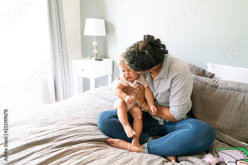 Mother consoling crying baby