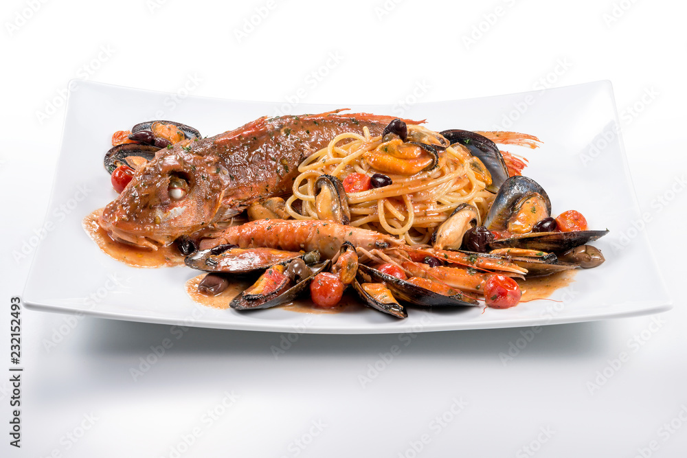 Plate of spaghetti with Tub gurnard prawn mussels olives and tomatoes Plate of spaghetti with Tub gurnard prawn mussels olives and tomatoes