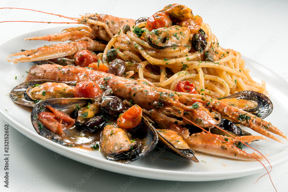 Plate of spaghetti with prawn mussels olives and tomatoes Plate of spaghetti with prawn mussels olives and tomatoes