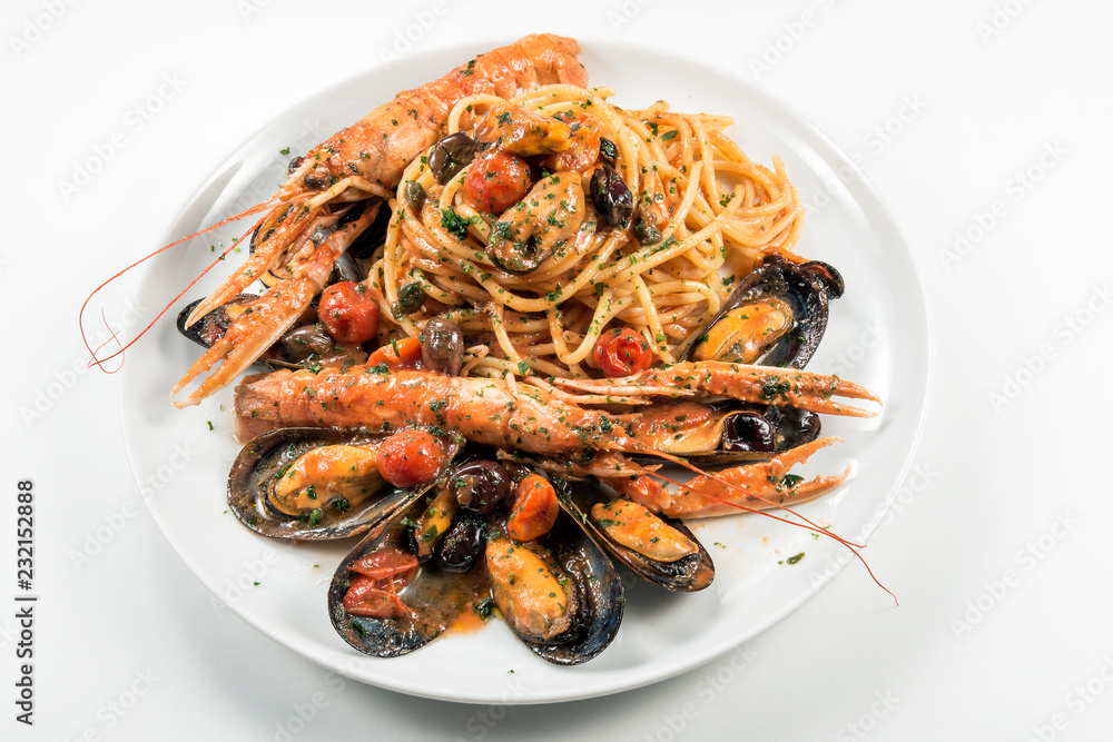 Plate of spaghetti with prawn mussels olives and tomatoes Plate of spaghetti with prawn mussels olives and tomatoes