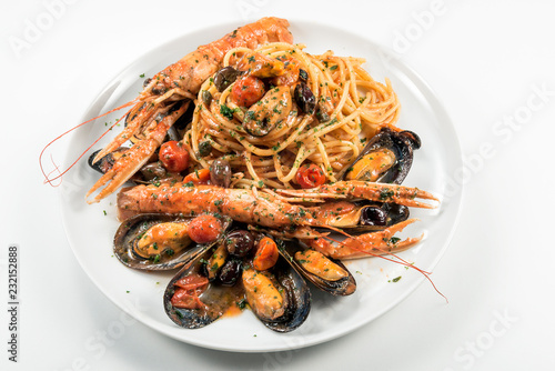 Plate of spaghetti with prawn mussels olives and tomatoes © antoniotruzzi