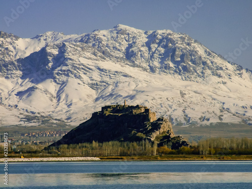 The view of Van castle, snowy monutains background. photo