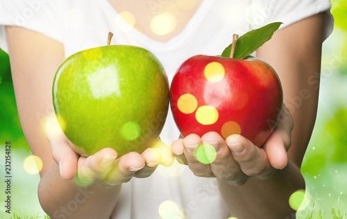 Woman holding two apples isolated on  background