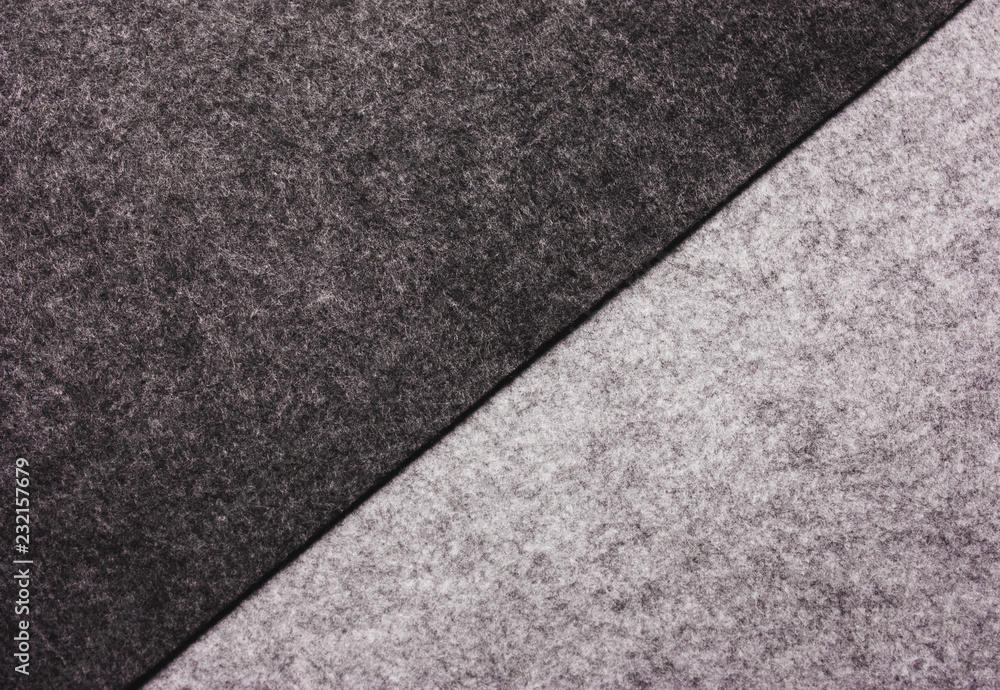 The texture of felt wool. Warm gray background.