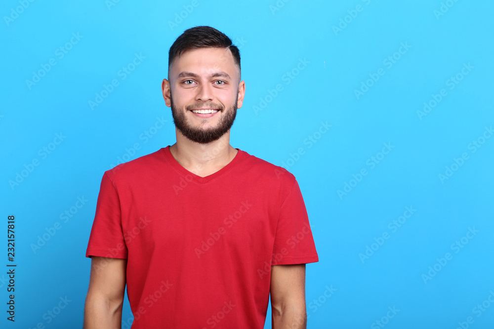 Young man in red t-shirt on blue background Young man in red t-shirt on blue background