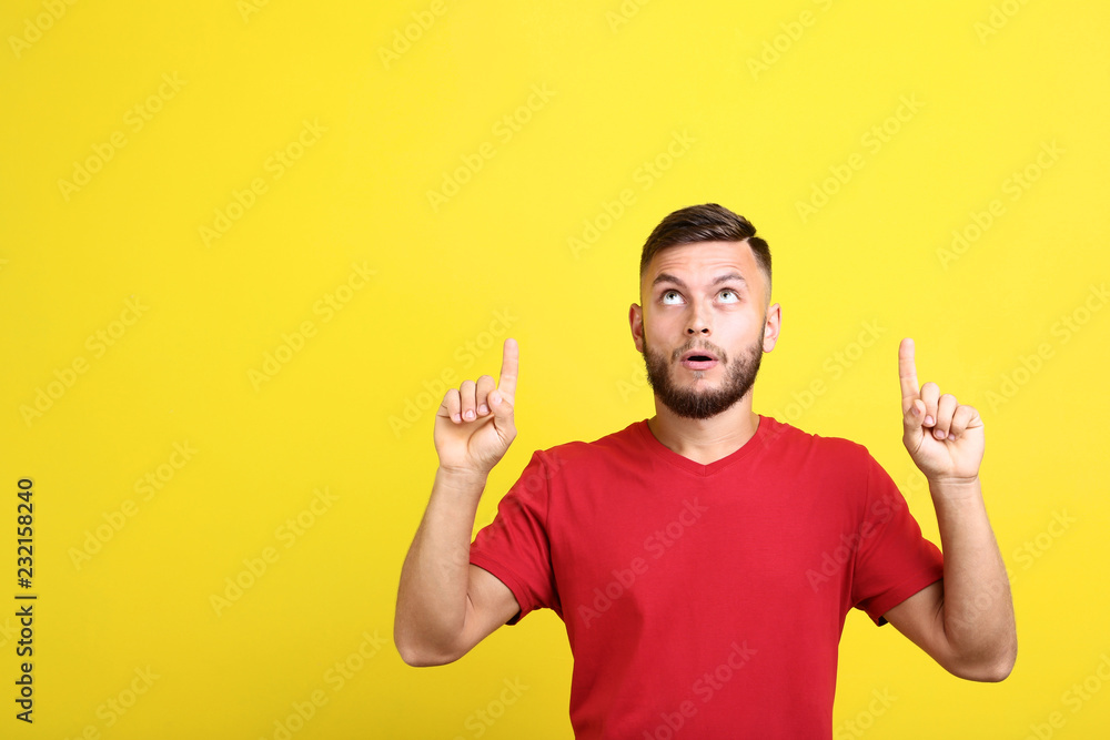 Young man in red t-shirt on yellow background Young man in red t-shirt on yellow background