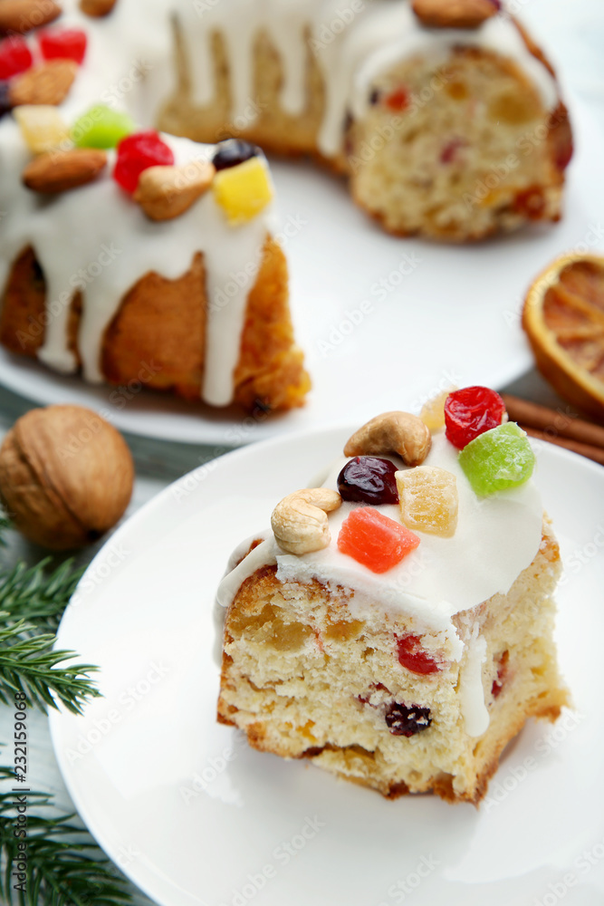 Slice of bundt cake with candied fruit and cashew in white plate Slice of bundt cake with candied fruit and cashew in white plate
