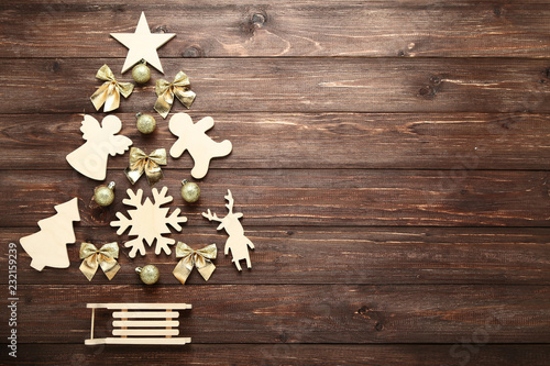 Decorations and baubles in shape of christmas tree on wooden table