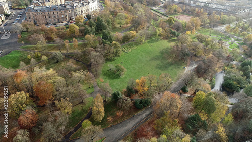 Low level aerial image over the autumn foliage of trees in Kelvingrove Park, Glasgow, to the elegant buildings of Park Circus. photo