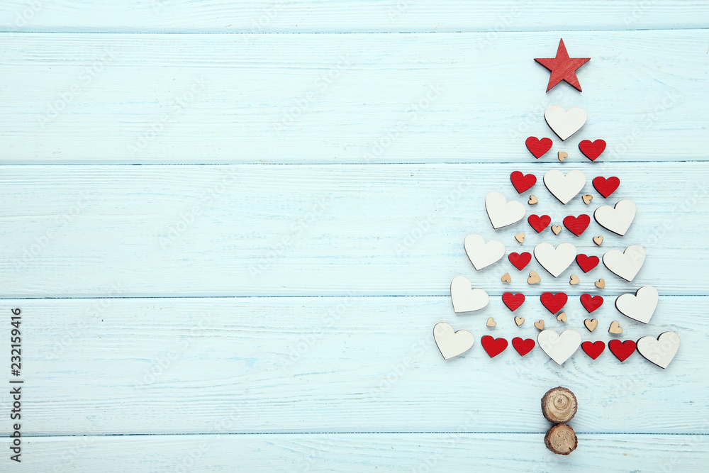 Small hearts in shape of christmas tree on wooden table