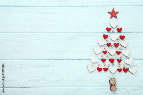 Small hearts in shape of christmas tree on wooden table