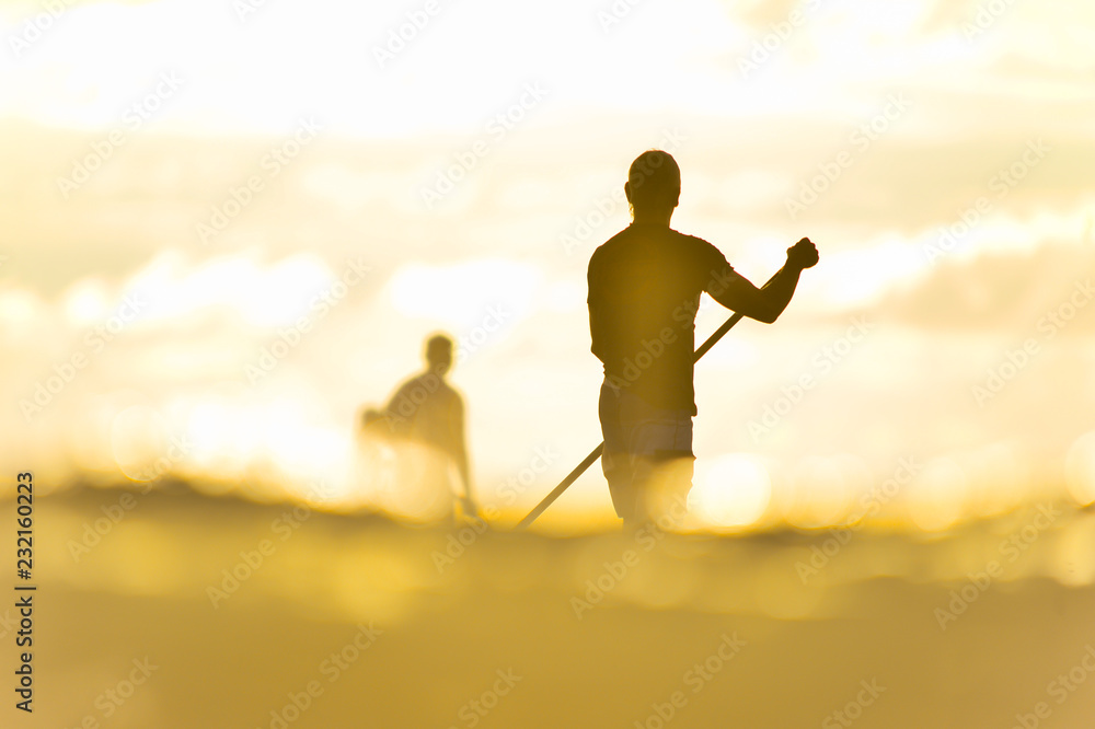 Fototapeta premium silhouette of stand up paddle board player in the sunset (actual short)
