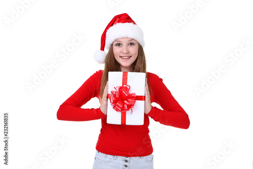 Young girl in santa hat holding gift box on white background