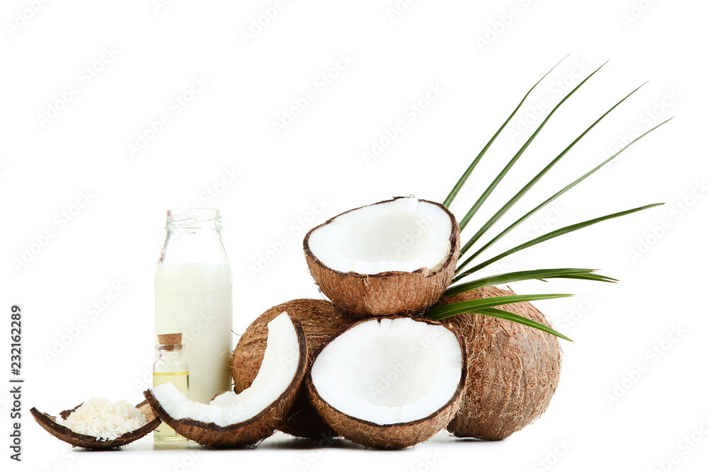 Coconut milk in bottle with oil and flakes on white background Coconut milk in bottle with oil and flakes on white background