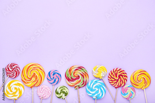 Colorful lollipops on purple background