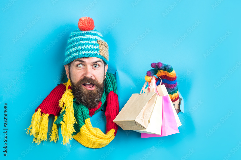 Shopping season. Black Friday and cyber Monday Sales day. Shopping and sale. Winter sale, shopping concept. Christmas man hold shopping bags through paper hole. Winter holiday and boxing day. New year