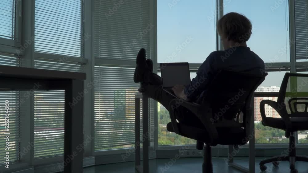 Office worker does his job with feet on table Office worker does his job with feet on table