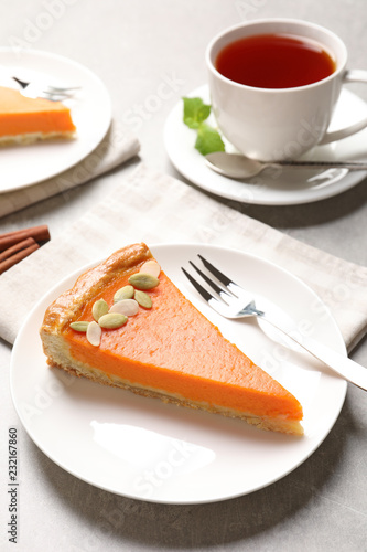 Plate with piece of fresh delicious homemade pumpkin pie on light table