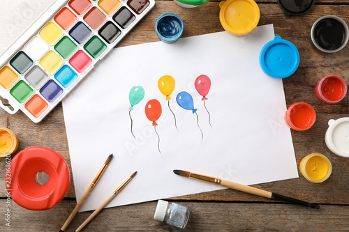 Flat lay composition with child's painting of balloons on table