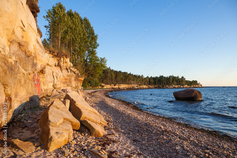 Limestone cliff on the coast of the Baltic sea. Sunset time and warm colors. Limestone cliff on the coast of the Baltic sea. Sunset time and warm colors.
