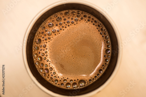 Basic lattte art coffee in a cup on wooden table.