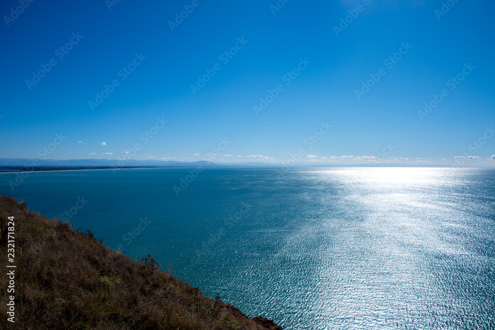 Coastal views of Taylors Mistake, Christchurch, New Zealand on a bright sunny day with blue sea