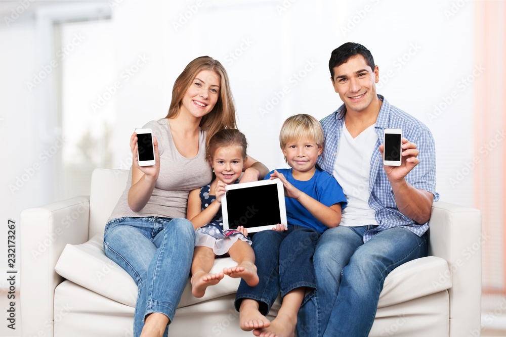 Beautiful smiling family in room on couch Beautiful smiling family in room on couch
