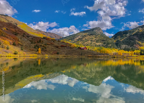 Reflection of yellow aspens on Lake in Colorado in Autumn