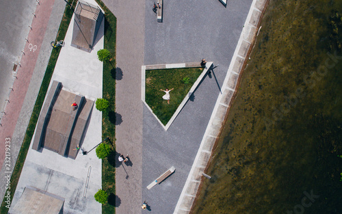 Surrealism. The girl lies on a green lawn in the recreation area on the waterfront next to the skate park Ternopil. Ukraine.