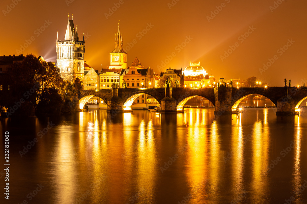 Vltava River and Charles Bridge with Old Town Bridge Tower by night, Prague, Czechia. UNESCO World Heritage Site.