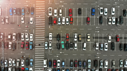 Drone fly above the parking lot with a cars